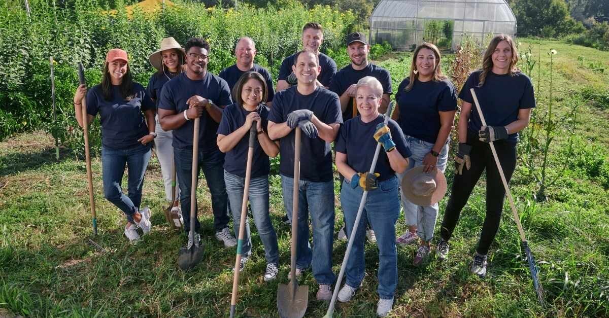 People with shovels volunteering in a garden