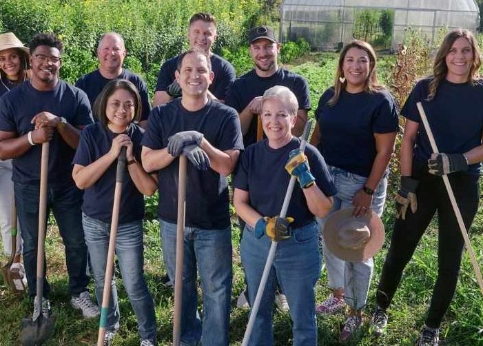People with shovels volunteering in a garden