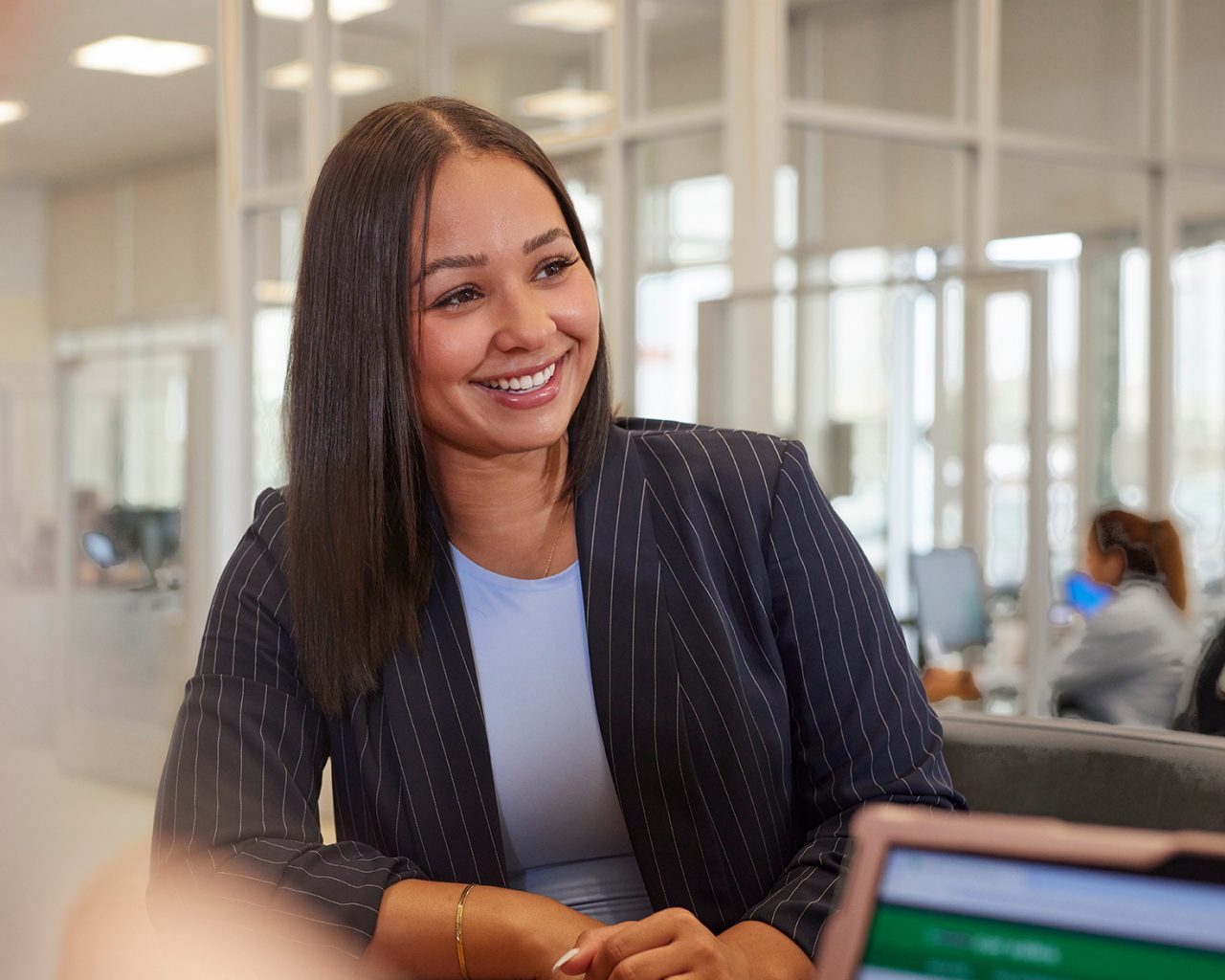 Enterprise Mobility team member talking to a customer in a local neighborhood retail branch office.