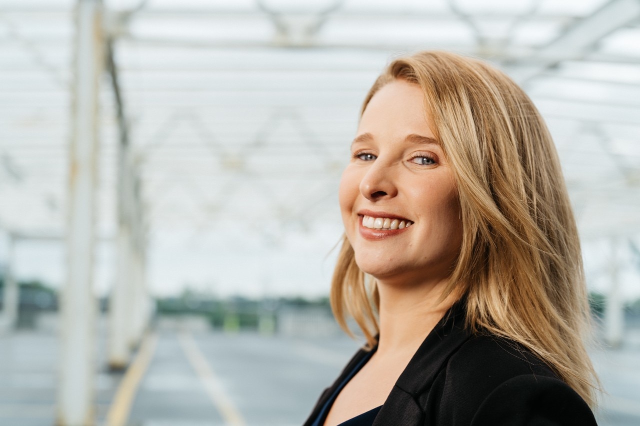 Girl standing on a bridge outside