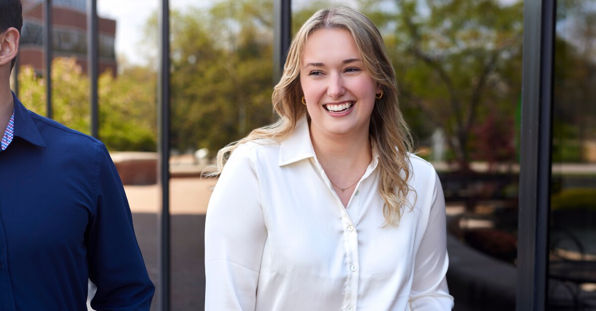 Enterprise Mobility employee walking campusgoing to use chatgpt to help students find and choose a university course