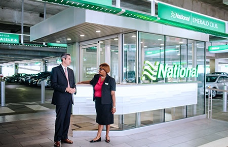 Two National employees talk to each other in a garage